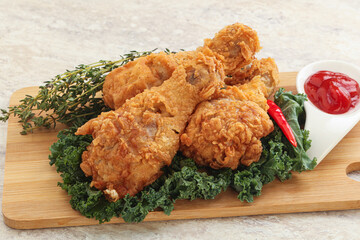 Fried chicken drumsticks with tomato sauce