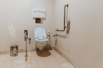 Modern toilet for people and people with disabilities with special equipment