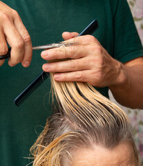 cutting blond hair with scissors as a background