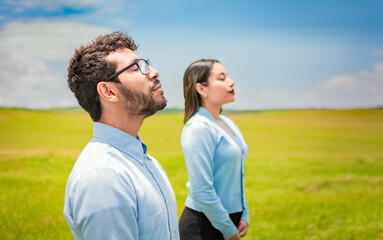 Obraz premium Concept of Young couple breathing fresh air with positive attitude, Two people breathing fresh air in the field, Young couple breathing fresh air in the field