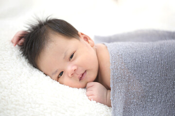 Obraz na płótnie Canvas Lovely newborn Asian baby sleeping on furry cloth