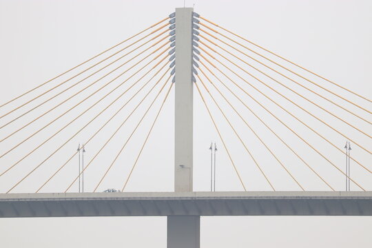 Cable stayed Bridge with set of yellow line cables supporting the structure. Atal-setu which is one of the biggest cable stayed bridges in India