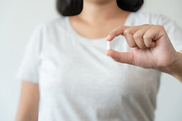 Woman carrying a supplement pill aspirin medicine health care concept. Get sick need a pill to recover good health.