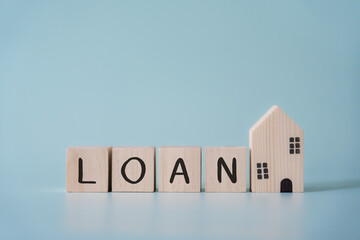 Wooden blocks wording loan and small house model concept of property lender service. Get a mortgage approval finding most advantage finalcially loan. © StockerThings
