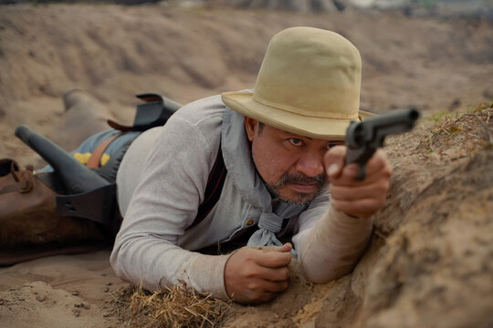 action figure of a man wearing a cowboy suit with a gun in his hand