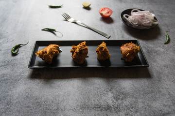 Pieces of kebabs served in a tray with use of selective focus. Close up. 