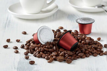 Closeup of roasted coffee beans and coffee capsules