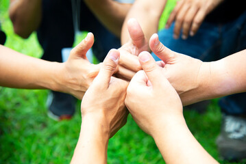 Teamwork Hands of spirit team working together outdoor. Unity strong handshake with people or...