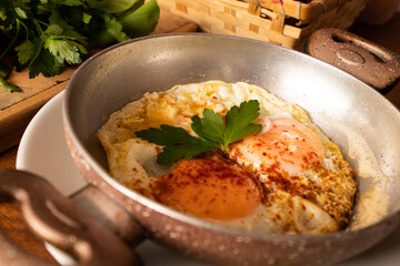 Fried eggs in copper pan. Turkish breakfast.