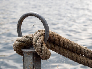 Mooring rope of a boat tied to a bollard.