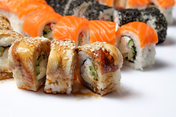 Tasty sushi and sushi roll set with wasabi and ginger on white background. Vegan sushi rolls. Seafood.