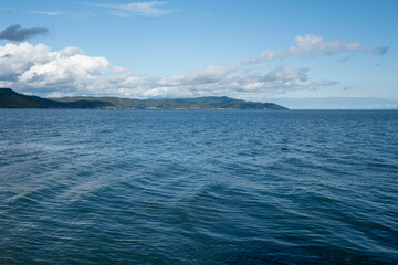 Beautiful view of Lake Baikal on a summer day. The clear calm surface of the lake