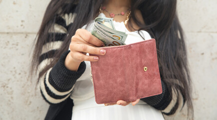 Woman hands with wallet and money.