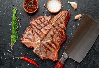 grilled T-bone steak or porterhouse Steak with herbs and salt on stone background