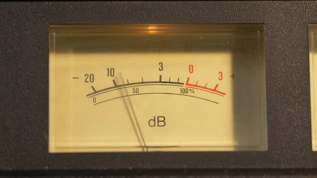 Sliding shot of a VU meter to another meter on a vintage cassette player
