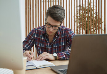 young man dressed in white shirt using laptop computer