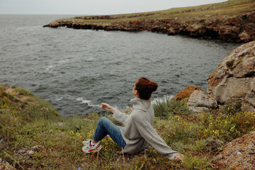 Naklejka na ściany i meble pretty woman nature rocks coast landscape Ocean Relaxation concept