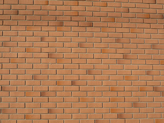 Brick textured wall background and with copy space. Brick wall. Modern red brick wall in gentle sunlight, full frame for texture use
