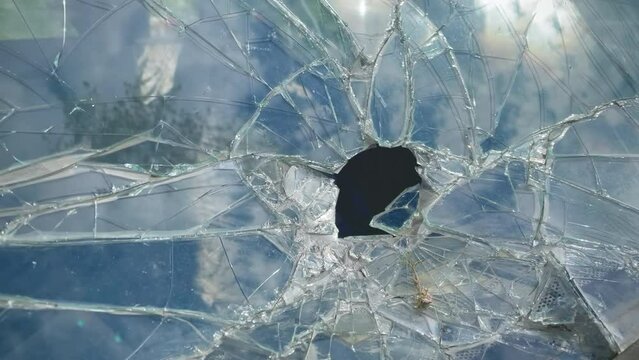 Broken car windshield close-up. Broken windshield in a car accident. Cracked glass details. Auto insurance. Old damaged car.