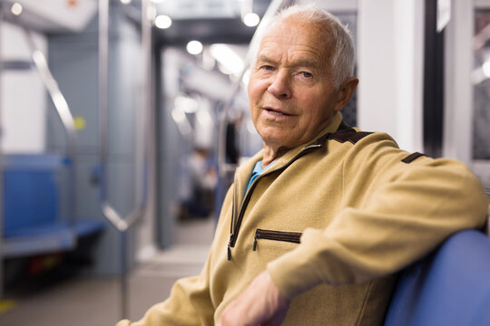 Portrait of elderly european man 75 years old sitting in underground carriage
