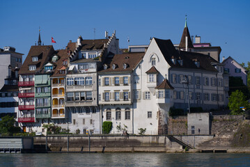 Fototapeta na wymiar Colorful facades of historic houses at border of Rhine River on a sunny spring day. Photo taken May 11th, 2022, Basel, Switzerland.
