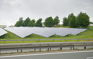 A lot of solar panels on the side of the road next to an autobahn highway in Bavaria, Germany....
