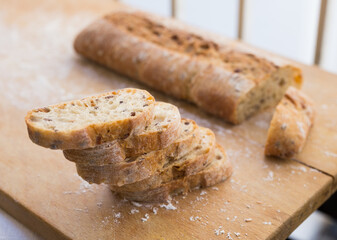 fresh loaf of bread on wooden board