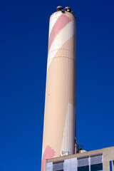 Chimney of Incineration plant at City of Basel on a sunny spring day. Photo taken May 11th, 2022, Basel, Switzerland.