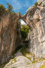 landscape of a natural arch-shaped bridge formed between two mountains