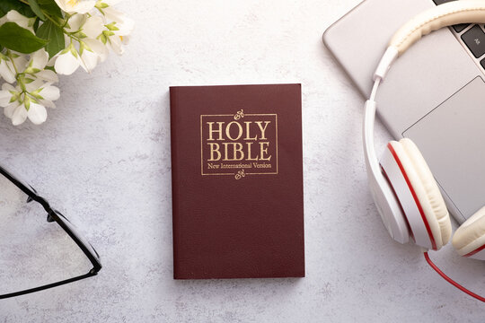 Top View of Holy Bible on working table with headphones