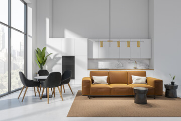 Studio interior with couch and table with armchairs, panoramic window