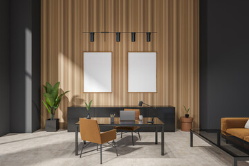 Modern office room interior with desk and laptop, couch and mockup frames