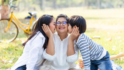 Group of Healthy multi generation Asian family enjoy picnic travel together at the park. Parents with cute child boy and healthy senior grandmother relax and having fun on summer holiday weekend