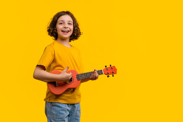 Child girl with ukulele in studio