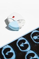 Asthma inhaler and CT scan of the lungs on white table. Aerosol for inhalation for treat lung inflammation and prevent asthma attack. - obrazy, fototapety, plakaty