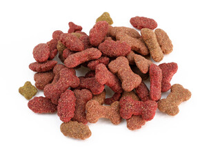 Dry meat food for pets on a white background. Heap of red dry dog food top view. Daily diet for pets.
