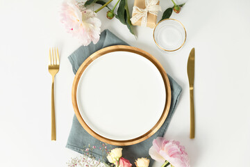 Beautiful table setting with golden cutlery and peony flowers, mock up