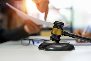 judge on wooden table And experienced lawyers meet with clients and give advice behind the scenes. legal services legal consulting concept