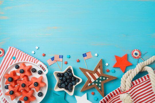 4th of July border design, Independence Day picnic background with fruit salad, beach bag and decorations. Top view, flat lay