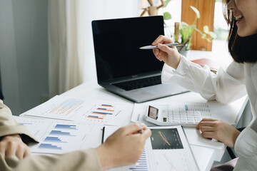 Negotiation, Analysis, Discussion, Asian woman economist and marketer pointing to a financial data...