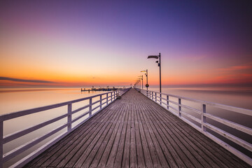 Amazing sunrise over the pier i Mechelinki. Baltic sea