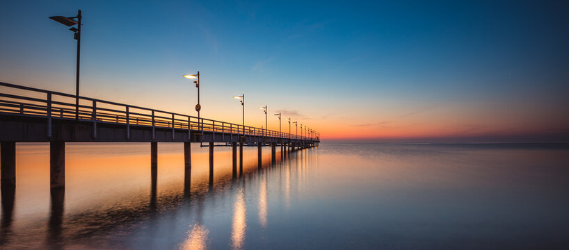 Fototapeta Amazing sunrise over the pier i Mechelinki. Baltic sea