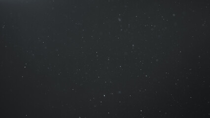 real dust particles in air with back light over black background