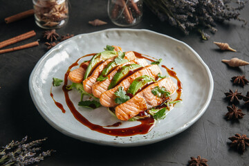 Plate of gourmet salmon and avocado appetizer with sauce