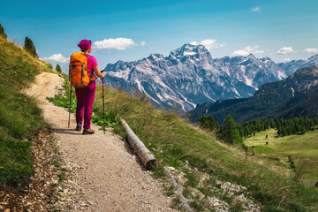 Hiker woman enjoying the view from the trail, Dolomites, Italy