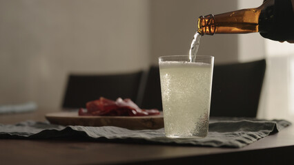 pour ginger drink in tumbler glass on table with copy space