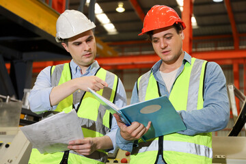 The Caucasian engineer talking and discussing in production line process after check and inspection the machine in factory, professional technician operating or work in manufacturing industrial