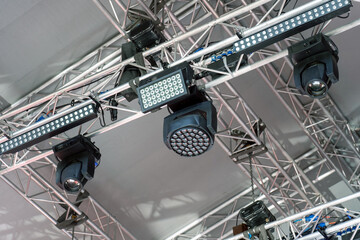Stage lighting equipment on outdoor stage. Entertainment concert lighting. Led lighting devices...