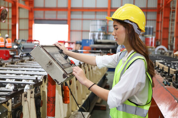 the lady worker or operator has operate the machine in production line factory, young woman check...