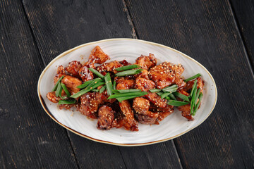Top view on korean fried yangnyeom chicken with spring onion